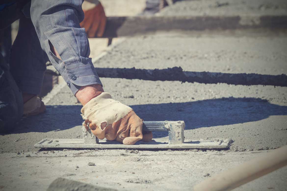 Construction Workers Leveling Concrete Pavement